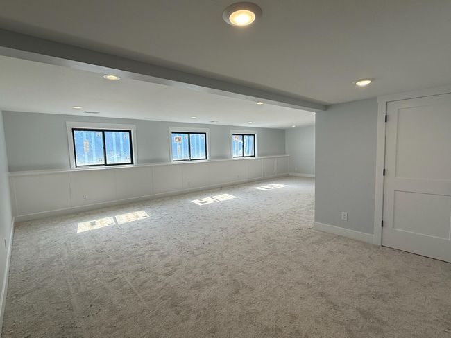 Daylight lower level-spacious family room with wall detail | Image 21