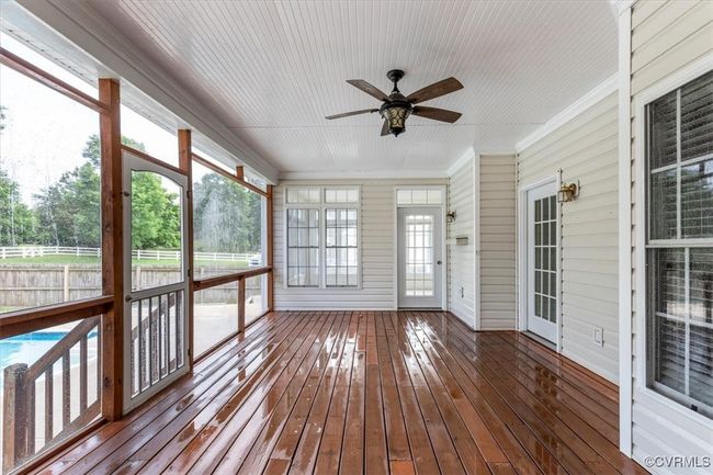 Unfurnished sunroom with a ceiling fan and plenty of natural light | Image 43