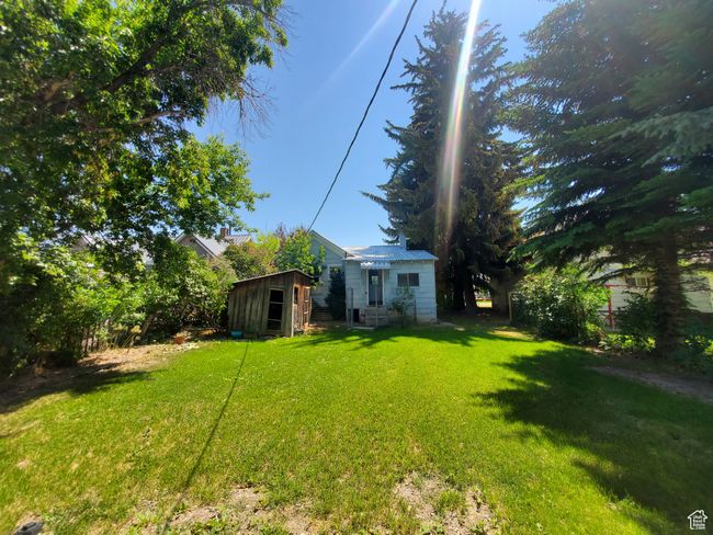 View of green lawn featuring a storage unit | Image 28