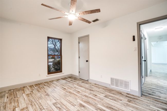 Unfurnished room with light wood-style flooring, a ceiling fan, and baseboards | Image 17