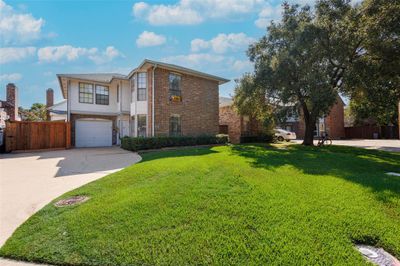 View of front property with a garage and a front lawn | Image 1