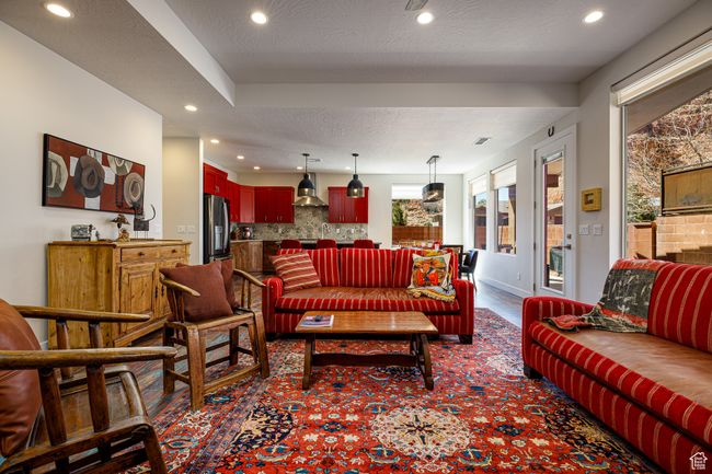 Living room featuring baseboards, a textured ceiling, and recessed lighting | Image 7