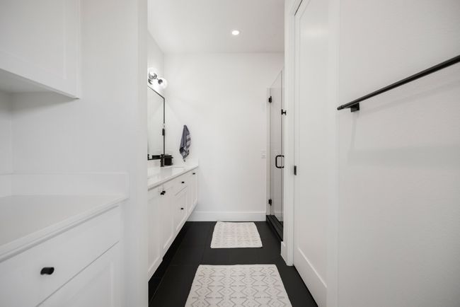 Primary full bath featuring recessed lighting, double vanity, a walk-in shower and tile patterned floors | Image 19