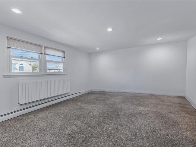 Spare room featuring radiator, recessed lighting, baseboards, and carpet | Image 17
