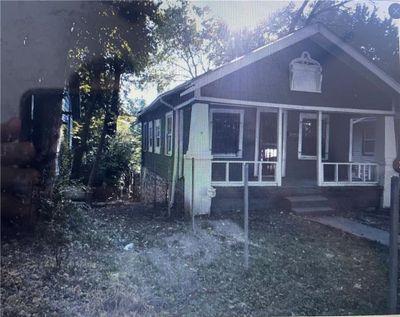 View of property exterior with a sunroom | Image 1