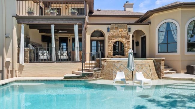Back of property featuring an outdoor pool, a balcony, and a patio | Image 24