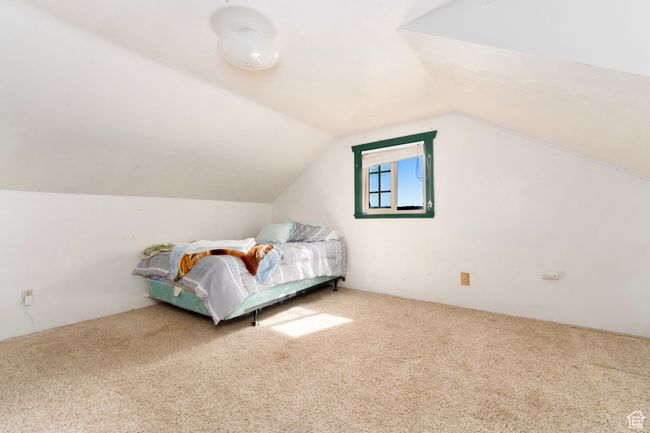 Carpeted bedroom featuring vaulted ceiling | Image 24