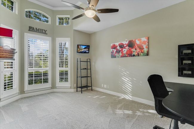Bedroom with carpet floors, a ceiling fan, crown molding, and baseboards | Image 18