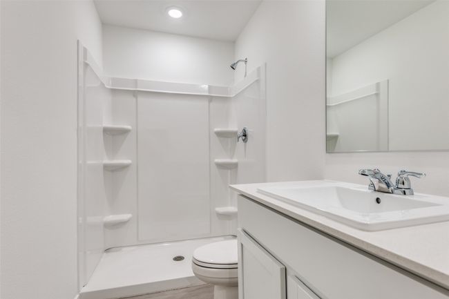 Full bath featuring vanity, a shower, and wood finished floors | Image 9