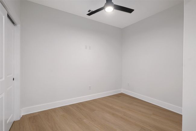 Spare room with light wood finished floors, baseboards, and ceiling fan | Image 13