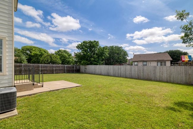 View of yard with central AC unit, a fenced backyard, and a patio area | Image 30