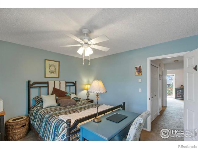 The blue walls and white trim create a bright and welcoming guest bedroom on upper level. | Image 14