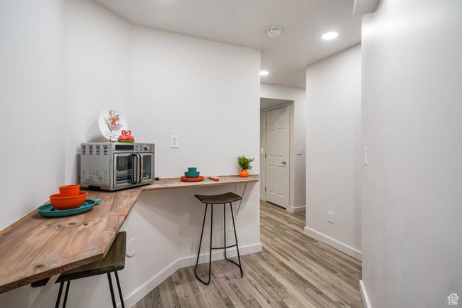 Kitchen with a kitchen breakfast bar, light wood-style flooring, and recessed lighting | Image 24