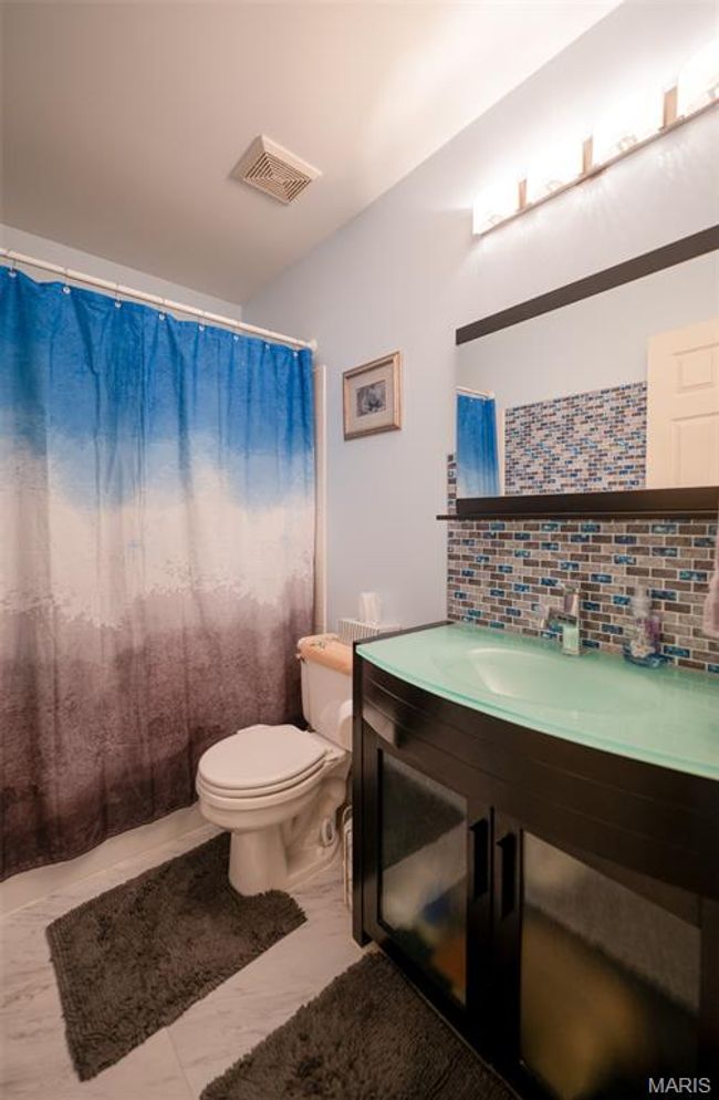 Bathroom featuring tasteful backsplash, vanity, and a shower with curtain | Image 36