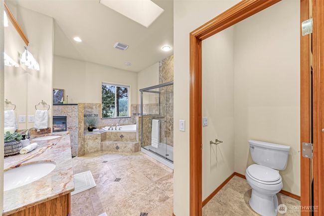 Private toilet room and glimpse of the fireplace in the primary | Image 15