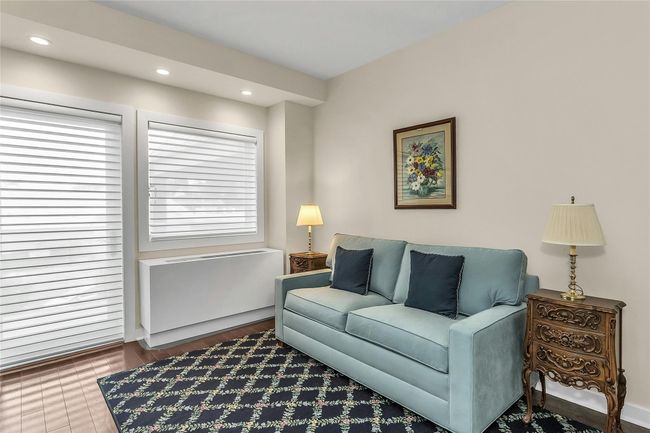Living area with healthy amount of natural light, recessed lighting, and radiator | Image 17