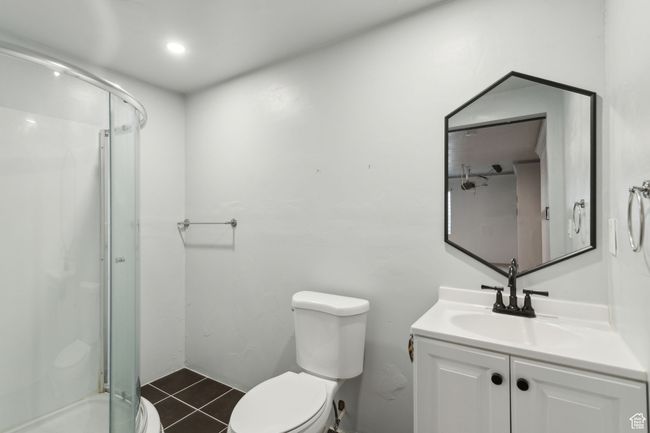 Basement 3/4 Bathroom featuring toilet, shower, tile patterned floors, and vanity | Image 28
