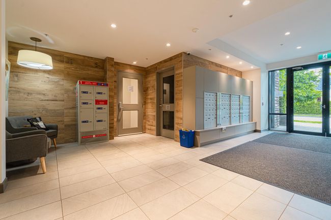 Building lobby featuring wooden walls, recessed lighting, and a security system | Image 6