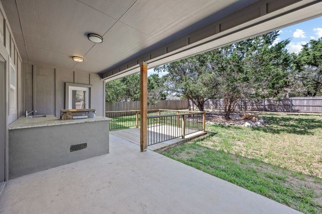 View of patio featuring a fenced backyard and a sink | Image 25