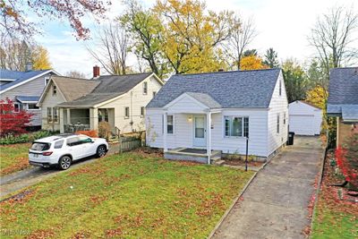 View of front of home featuring a garage, an outdoor structure, a front yard, and a porch | Image 3