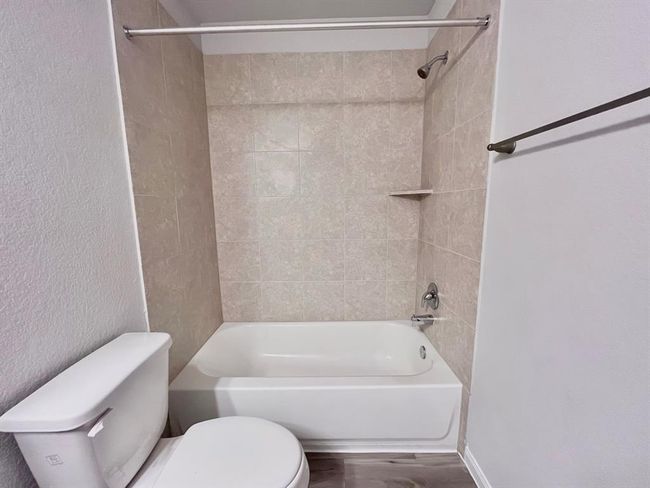 Elegant bathroom with modern finishes, featuring a sleek tub and neutral tile design. Virtually staged for inspiration. | Image 32