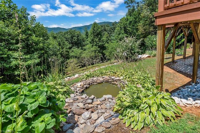 Step into the inviting warmth of this rustic cabin featuring a charming all-wood interior, complemented by an elegant entrance and convenient half bath, blending comfort and natural beauty effortlessly. | Image 12