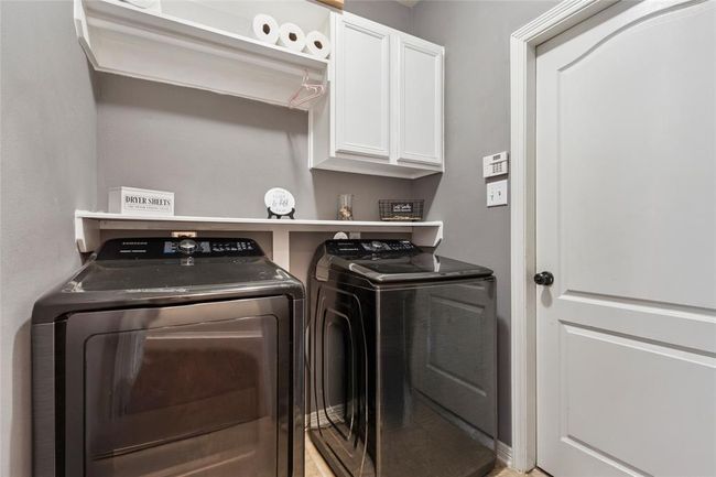 Nice size laundry room with shelves, cabinets and hanging rack. | Image 20