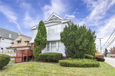 View of front of house featuring a deck and a front yard | Image 1