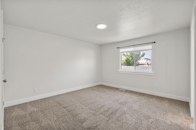 Carpeted empty room featuring baseboards | Image 18