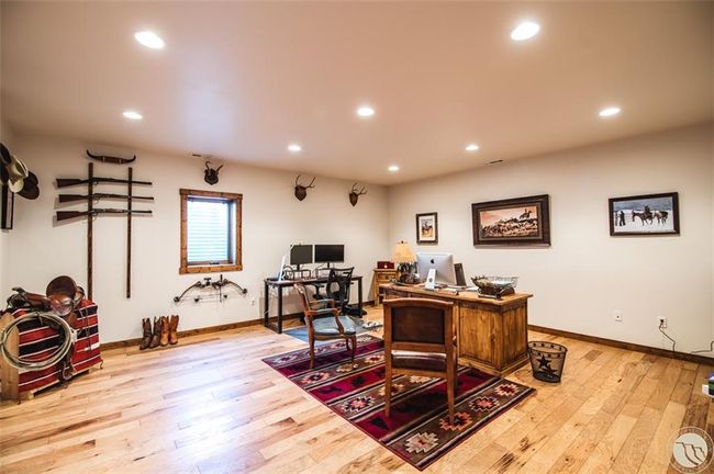 The den or bedroom downstairs has beautiful hardwood, full egress, and a walkin closet | Image 26