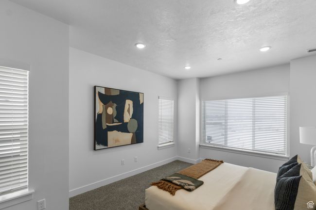 Bedroom featuring recessed lighting, carpet flooring, baseboards, visible vents, and a textured ceiling | Image 11