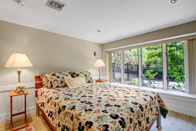 Bedroom featuring visible vents, baseboards, and light wood-style floors | Image 23