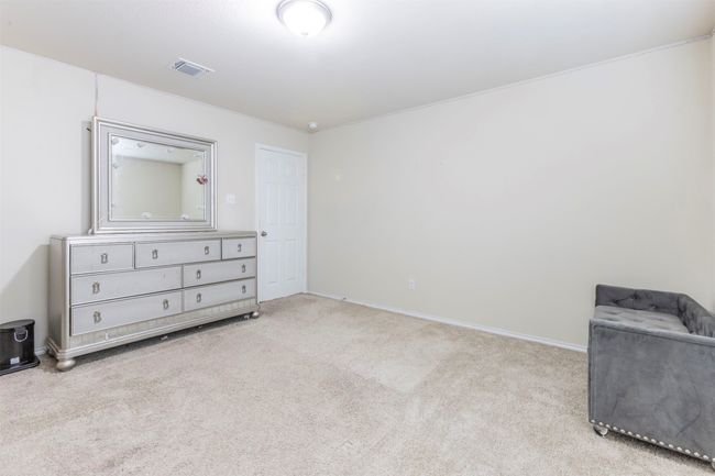 Unfurnished bedroom with visible vents, carpet, and baseboards | Image 31