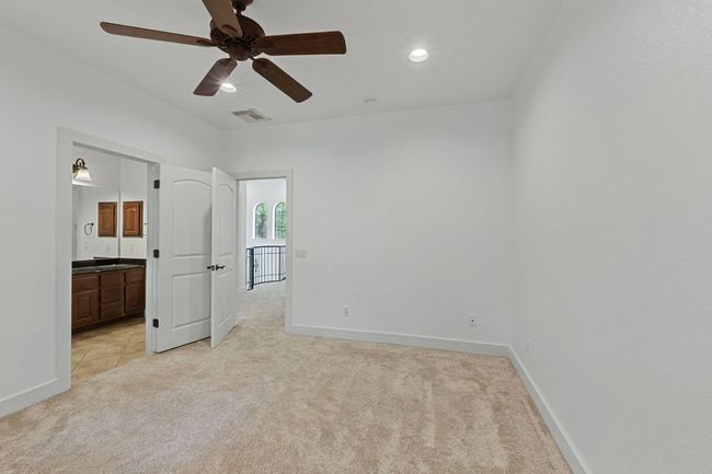 Unfurnished bedroom featuring light carpet, recessed lighting, ensuite bath, and a ceiling fan | Image 25
