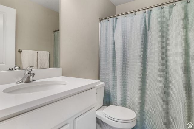 Bathroom featuring toilet and vanity | Image 11