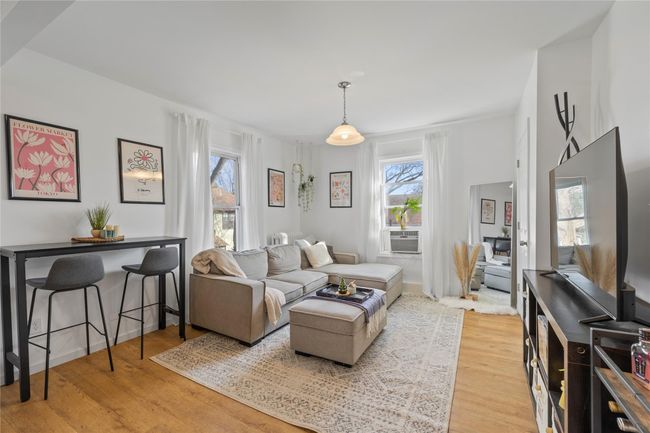 Living room featuring cooling unit and wood-type flooring | Image 4