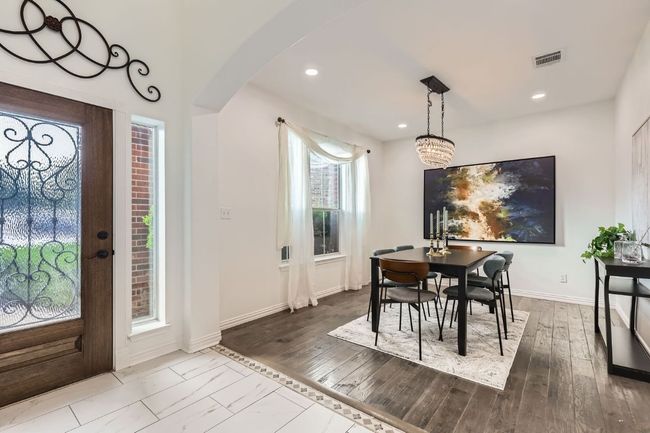 Dining area with arched walkways, baseboards, recessed lighting, and wood finished floors | Image 5