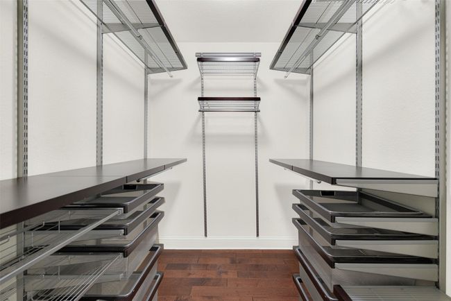 Spacious closet with dark wood-type flooring | Image 17