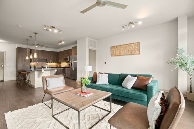 Living area with track lighting, a ceiling fan, and dark wood-style floors | Image 23