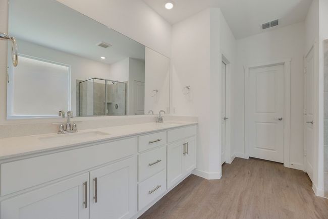 Full bathroom featuring a stall shower, double vanity, wood finished floors, and recessed lighting | Image 21