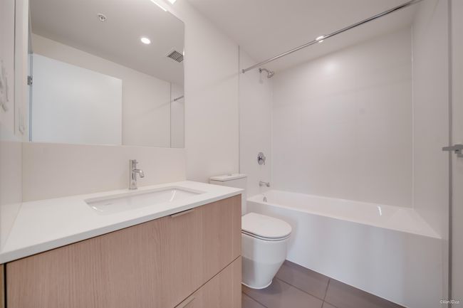 Bathroom featuring toilet, vanity, bathing tub / shower combination, and tile patterned floors | Image 11