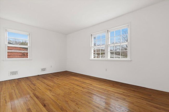 Spare room with visible vents, hardwood / wood-style flooring, and a healthy amount of sunlight | Image 21