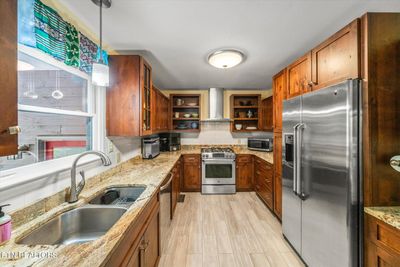 Updated kitchen with alder wood custom cabinets and granite counters | Image 3