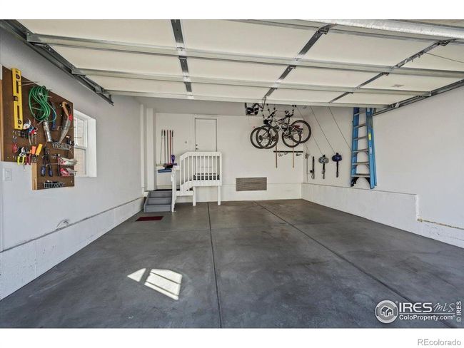 Garage with bicycle holders and storage racks above door | Image 29