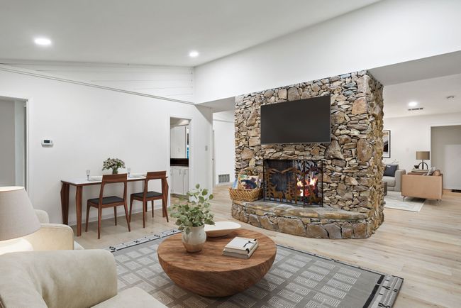 Virtually Staged Living area with wood finished floors, a stone fireplace, and recessed lighting | Image 6