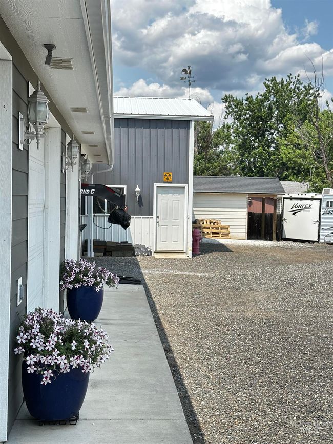View of garage doors toward shop and shed | Image 48