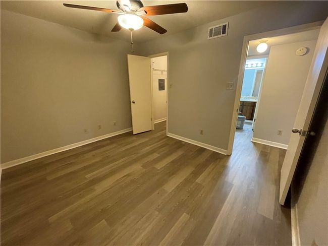 Unfurnished room featuring dark hardwood / wood-style flooring and ceiling fan | Image 12