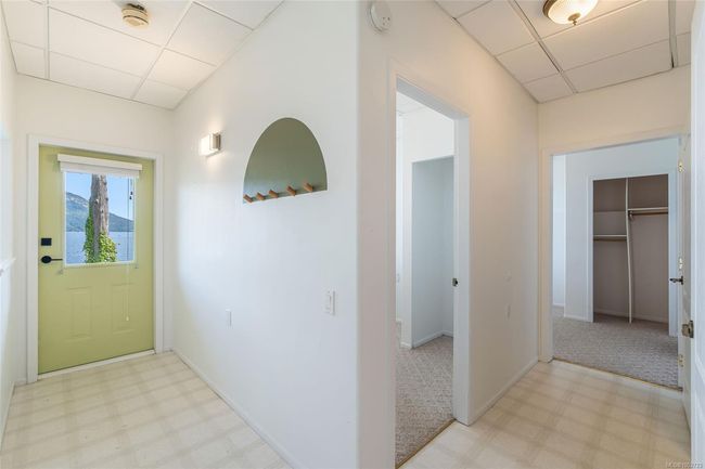Foyer featuring a drop ceiling, light floors, and baseboards | Image 48