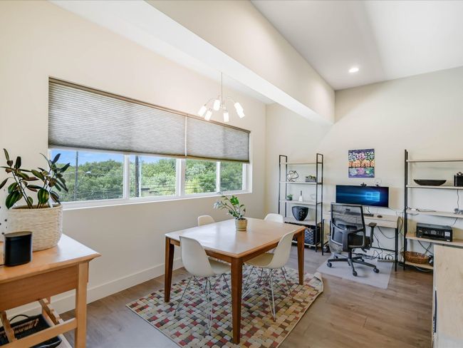 Office space with a chandelier, light wood-style floors, and recessed lighting | Image 9
