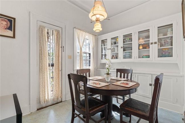 Breakfast room with built in cabinets, vintage lighting, and side door entry. | Image 10